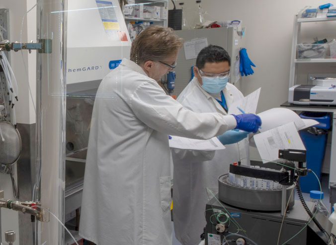 Two individuals working in a laboratory